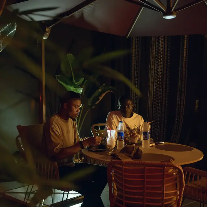 Friends at a table on a warm evening at Brisa